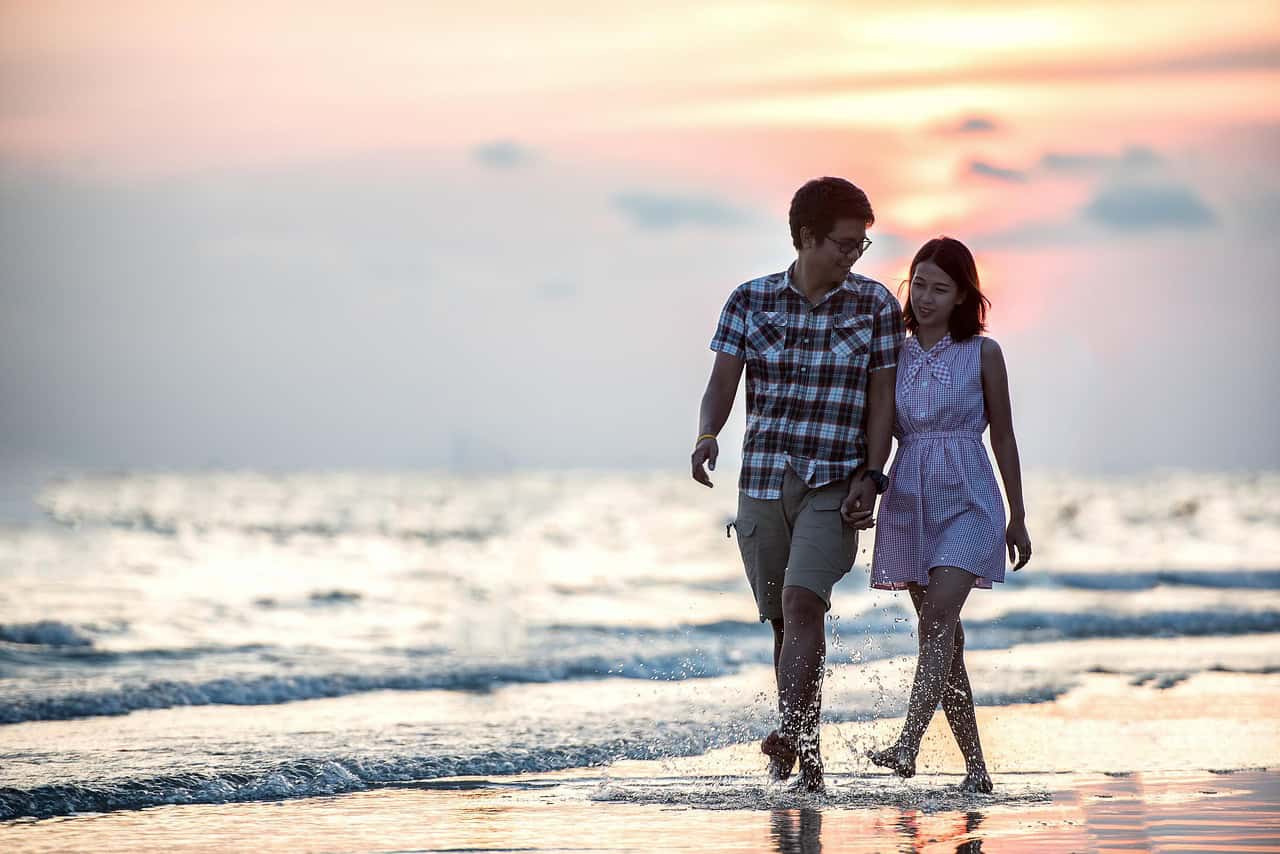 Couple walking on a Florida beach at sunset