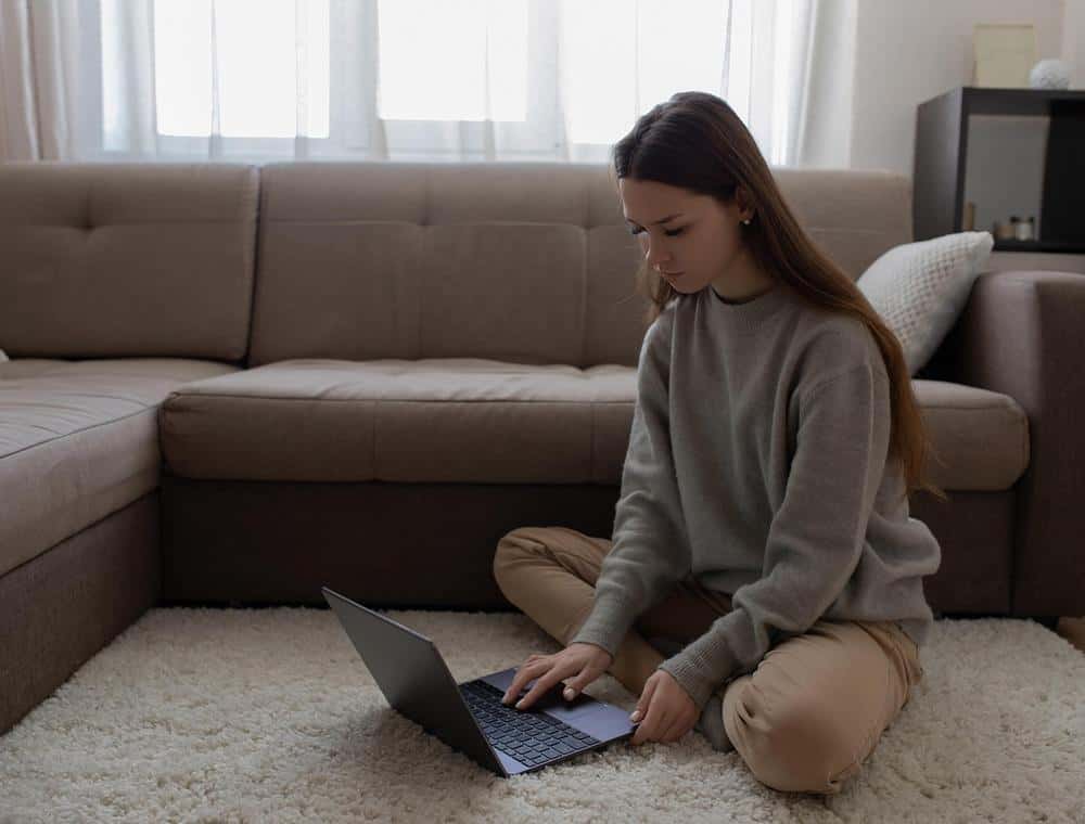 Woman checking her account on a laptop at home